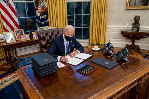 President Biden signed executive orders during his first few minutes in the Oval Office on Wednesday.Credit...