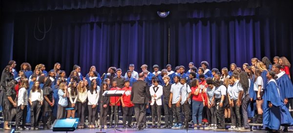 The combined chorus sings Cantique de Noel in a final performance